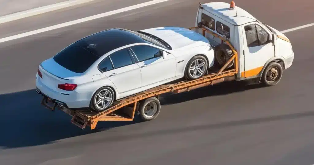 Professional tow truck towing a vehicle on a Sacramento roadway