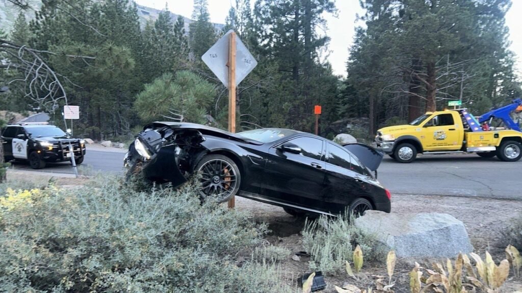 Damaged car off the road among the pines, waiting for accident recovery in South Lake Tahoe