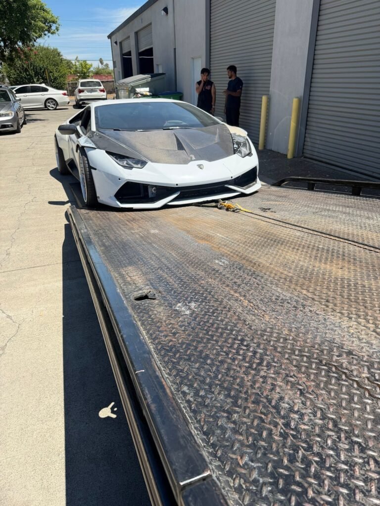 White Lamborghini loaded on a Sun City Towing flatbed in Sacramento