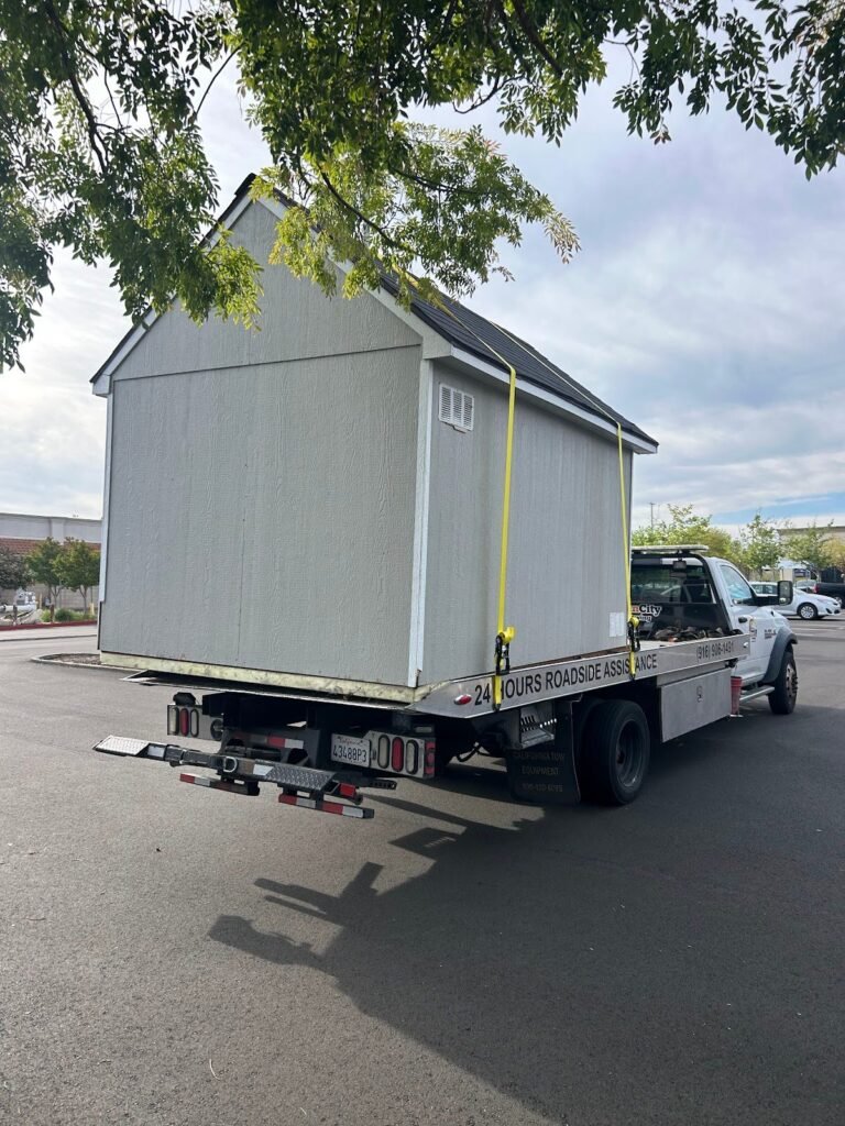 Storage shed loaded on a flatbed for specialized transport