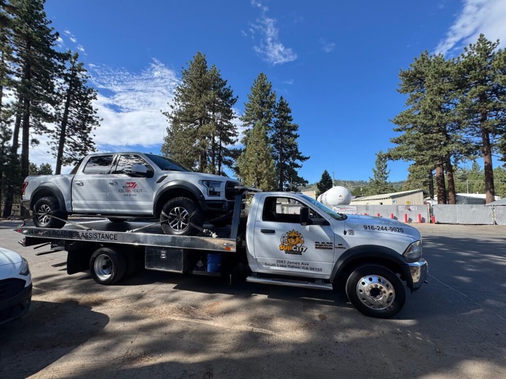 Sun City Towing flatbed carrying an SUV in South Lake Tahoe