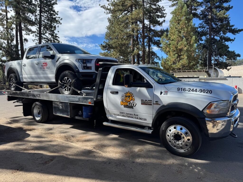 Sun City Towing flatbed hauling an SUV in South Lake Tahoe